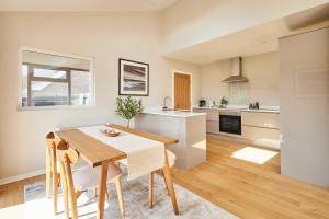a kitchen and dining room with a table and chairs at Host & Stay - Stille House in Beadnell +27 photos