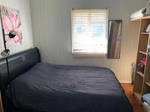 a bedroom with a bed in a room with a window at Kinnoull in Brisbane
