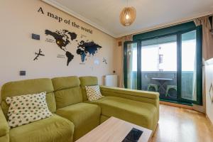 a living room with a couch and a map of the world at Salinas Surf Paradise in Salinas