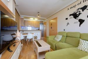 a living room with a couch and a kitchen at Salinas Surf Paradise in Salinas