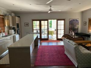 a kitchen and living room with a couch and a table at Kinnoull in Brisbane