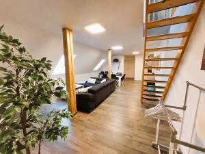 a living room with a couch and a staircase at FeWo Mäusehaus ID 16291-7 in Kargow