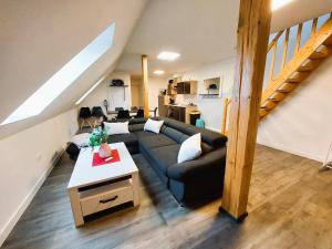 a living room with a couch and a table at FeWo Mäusehaus ID 16291-7 in Kargow