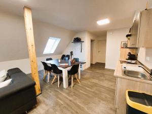 a kitchen and dining room with a table and chairs at FeWo Mäusehaus ID 16291-7 in Kargow +8 photos