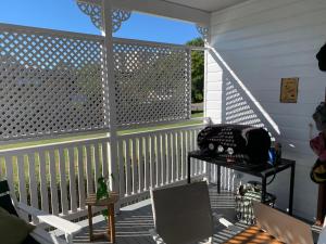 a screened in porch with a white fence at Kinnoull in Brisbane +3 photos