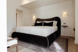 a large bed with a black headboard in a room at Sola Studios in Margaret River Town