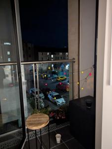 a balcony with a chair and a view of a parking lot at Cosy Centre in Dundee