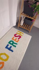 a rug with the word play on it on a floor at Cosy Centre in Dundee