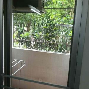 a bathroom window with a view of a plant at Viriyapon in Bangkok