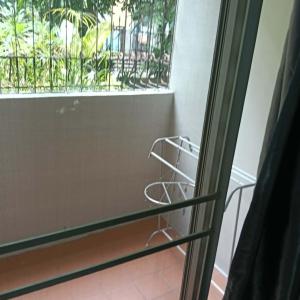 a room with a window and a metal rack at Viriyapon in Bangkok