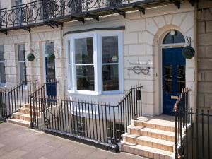 a building with a blue door and stairs at The Leam Hotel in Weymouth
