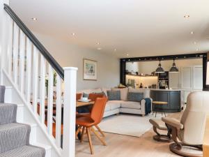 a living room with a couch and a table at Duke's Barn in Totnes