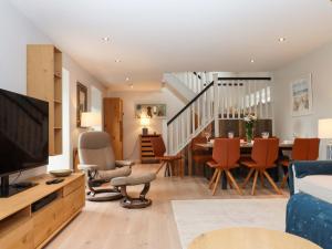 a living room with a television and a dining room at Duke's Barn in Totnes