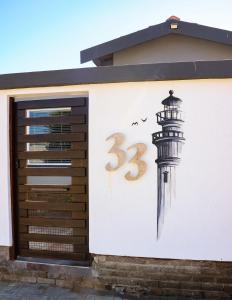 a mural of a lighthouse on the side of a building at A Lighthousee delight in Swakopmund +11 photos