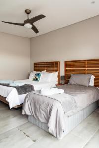 a bedroom with two beds and a ceiling fan at Hole Inn 1 in Robertson