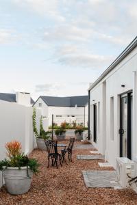 a patio with two chairs and a table at Hole Inn 1 in Robertson