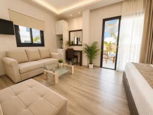 a large living room with a couch and a bed at ABATON Luxury Resort in Tsilivi
