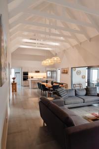 a living room with couches and a dining room at Hole Inn 1 in Robertson