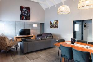 a living room with a couch and a table at Hole Inn 1 in Robertson