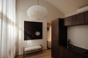 a living room with a pendant light and a bench at Sola Studios in Margaret River Town