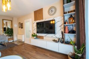 a living room with a flat screen tv on a wall at Villa Bella in Mostar