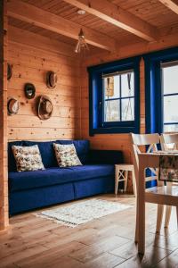 a blue couch in a room with wooden walls at Tu W Dolinie in Ropica Górna