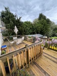 a wooden deck with a chair and an umbrella at Reads Park No 2 in Galbally +15 photos