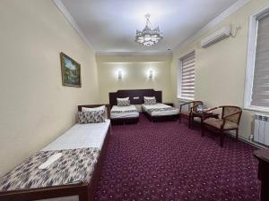 a living room with two beds and a couch at Grand Silk Road in Samarkand