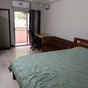 a bedroom with a bed and a couch and a desk at Viriyapon in Bangkok