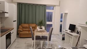 a living room with a table and a chair at Skizzo residence in Santa Maria degli Angeli