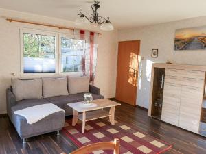 a living room with a couch and a table at Ferienhaus Bohne in Rubitz