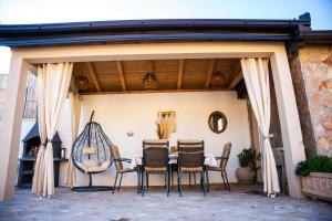 a patio with a table and chairs on it at Villa Bella in Mostar
