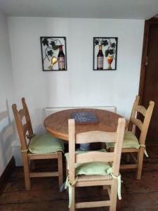 a table with two chairs and a table with bottles on the wall at The Courtyard Hideout in Hereford +7 photos