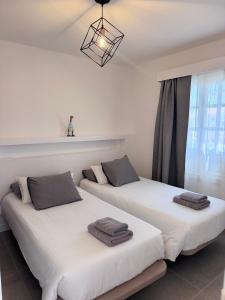 two beds sitting next to each other in a room at La Concha del Mar in Corralejo +190 photos