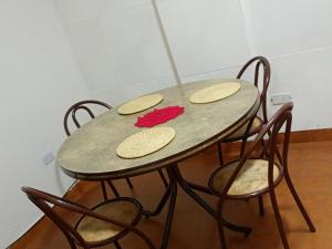 a table with four chairs and a table with cookies on it at Lindo recuerdos in Posadas