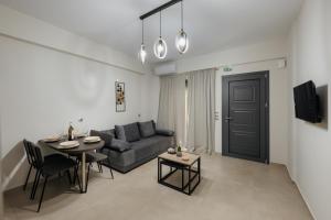 a living room with a couch and a table at Soro Rooms in Kanali