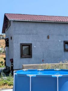 a blue ping pong table in front of a building at River Home in Kʼaghsi