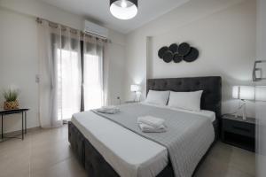 a bedroom with a large bed with two towels on it at Soro Rooms in Kanali