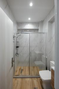 a glass shower in a bathroom with a toilet at Soro Rooms in Kanali +31 photos