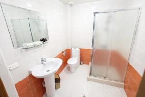 a bathroom with a shower and a sink and a toilet at Gyumri Hotel in Gyumri