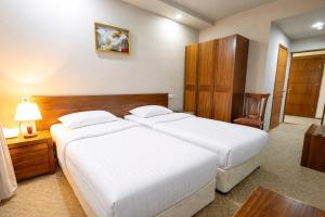 a hotel room with two beds and a table at Gyumri Hotel in Gyumri
