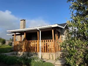 a house with a wooden fence in front of it at Idan Barn Suites & Café in Naro Moru