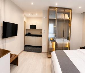 a hotel room with a bed and a kitchen at Stay Inn 51 Hotel Zayed in Sheikh Zayed