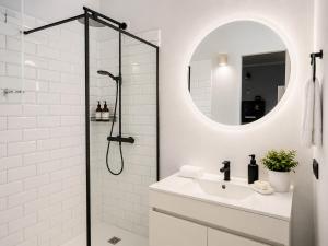 a white bathroom with a sink and a shower at Villa Claus - Private Pool Oasis in Puerto Calero in Puerto Calero