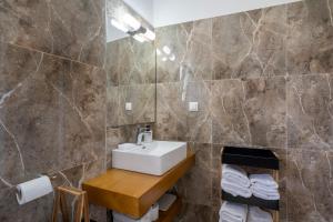 a bathroom with a sink and a mirror at Red Dragon Exclusive accommodation in Dassia +68 photos
