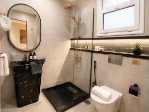a bathroom with a shower and a toilet and a mirror at Stay Inn 51 Hotel Zayed in Sheikh Zayed +22 photos