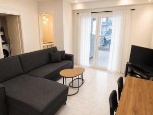 a living room with a couch and a table at Elenis Garden View Apartment in Perea