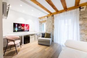 a living room with a tv and a couch and chair at Grgur Ninski Rooms in Split +44 photos