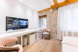a room with a white desk with a tv on it at Grgur Ninski Rooms in Split