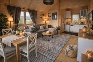 a living room with a couch and a table at Huberkowe Domki in Swiecko